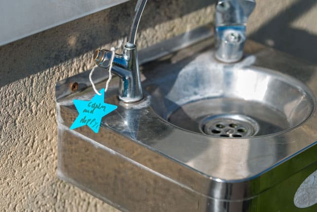 Water fountain with tag reading calm and happy